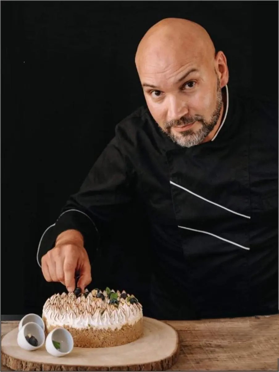 Chef Dinis Pinto a finalizar produto de pastelaria — precisão artesanal e rigor técnico de 33 anos de carreira